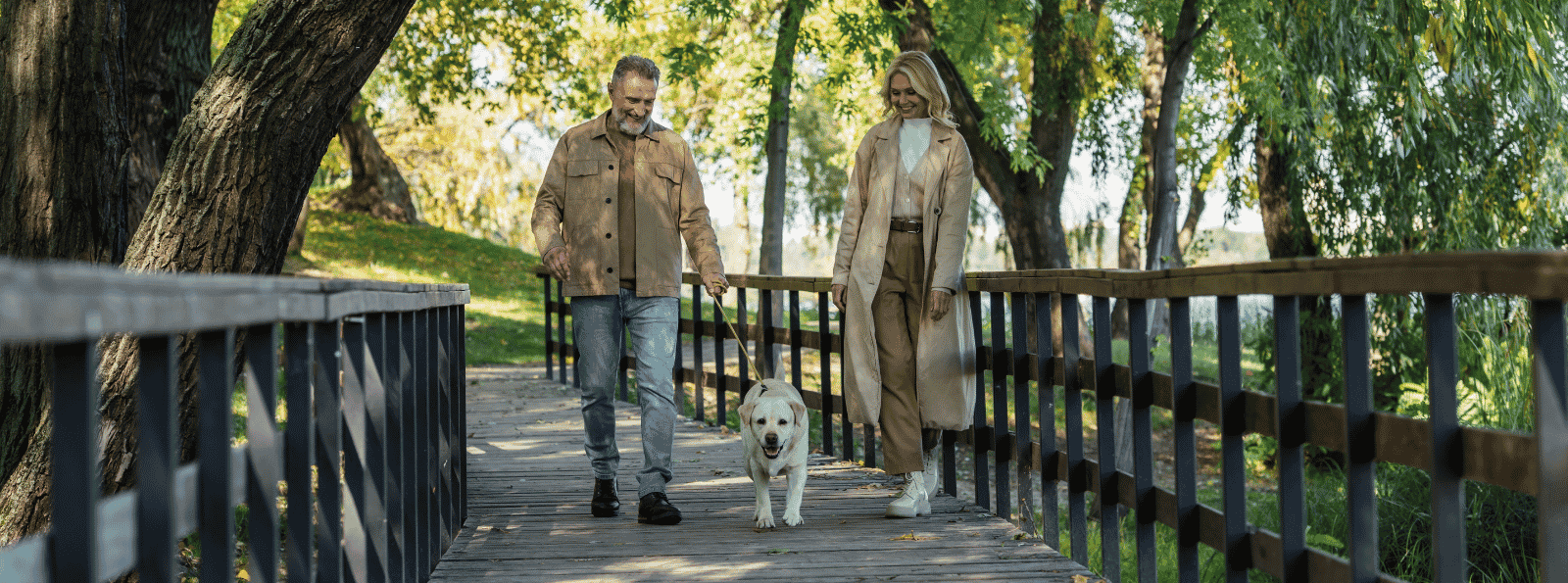 Older couple with dog on bridge