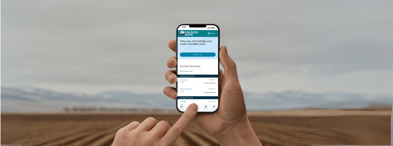 Using bank mobile app with field and mountains in background
