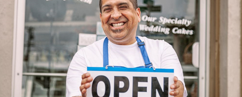 Business owner holding open sign